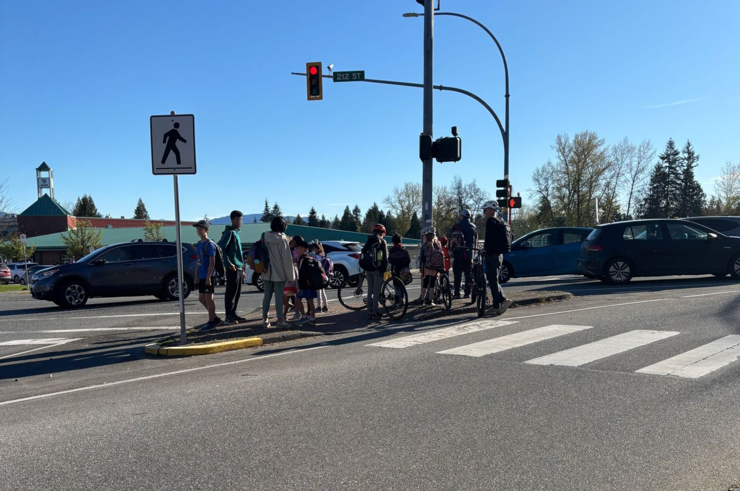 Crowded pedestrian island at Walnut Grove Drive and 212 Street intersection