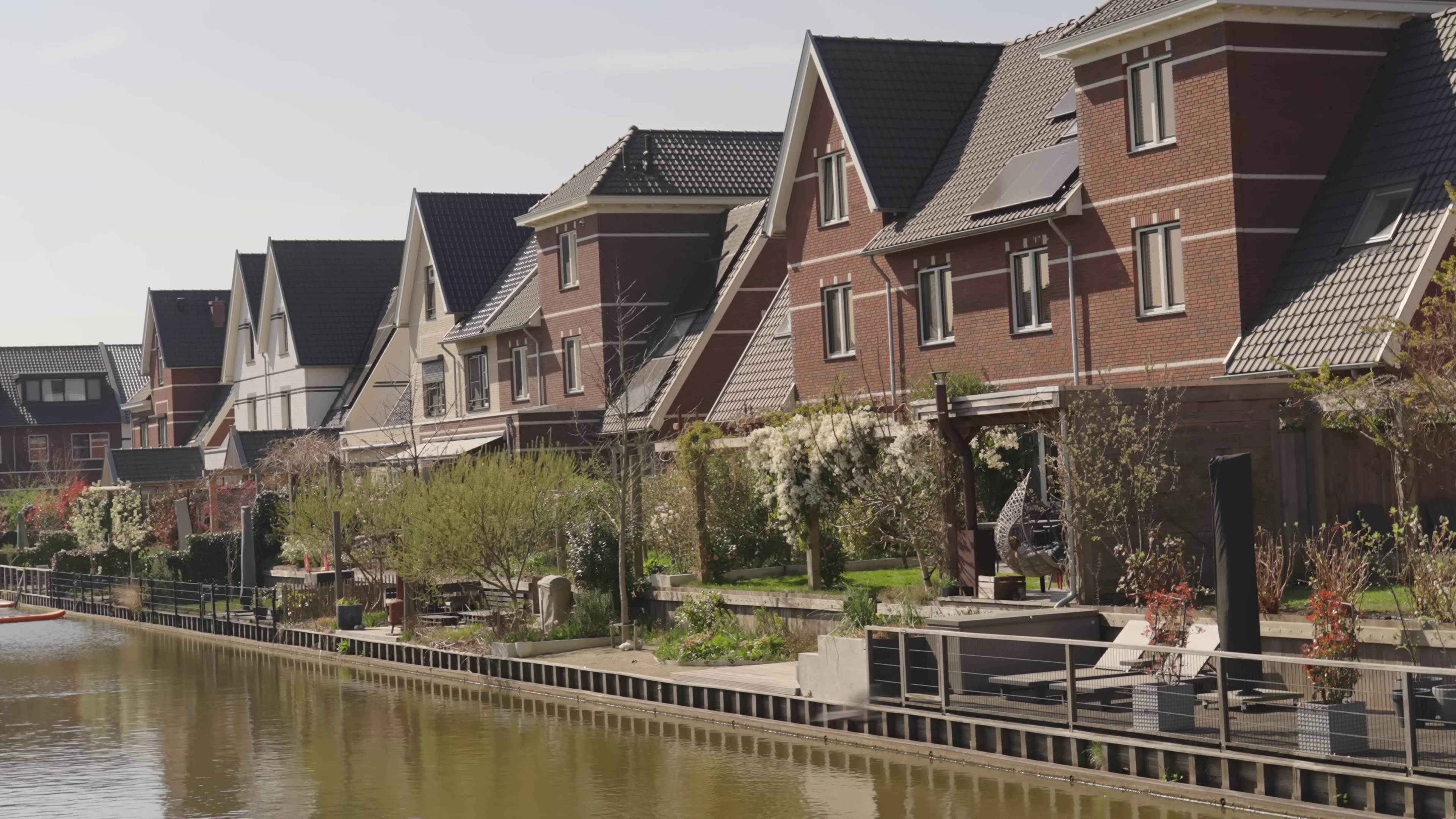 Houses on the waterfront with gardens